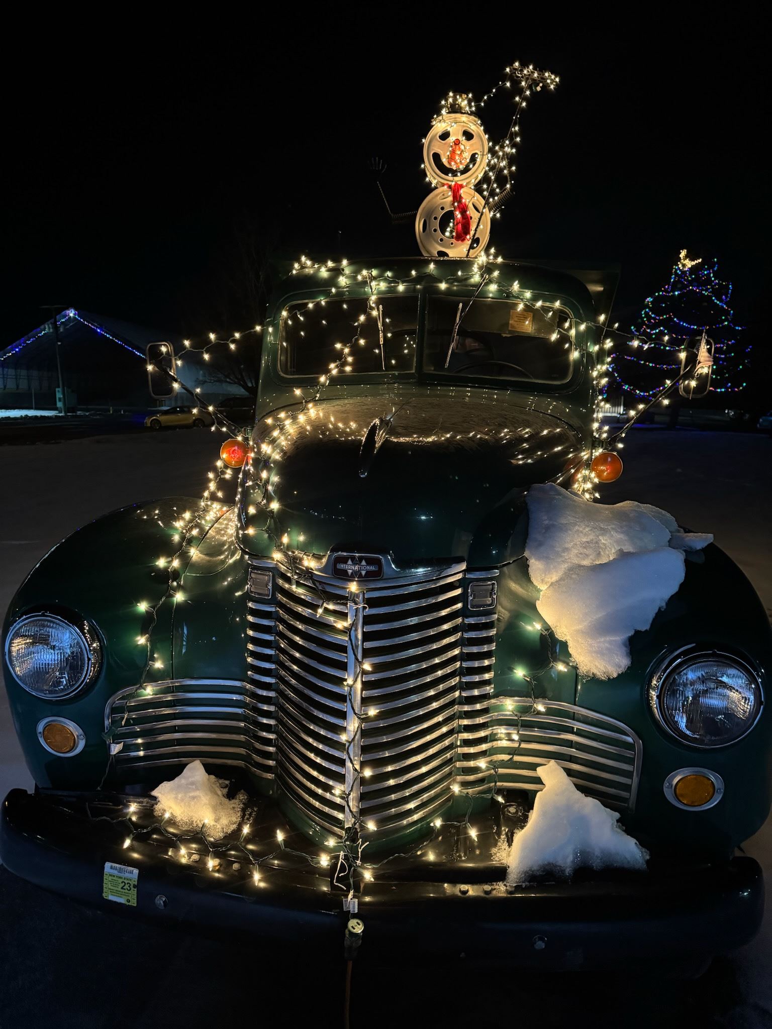 Snowman on green Highway truck with Christmas lights