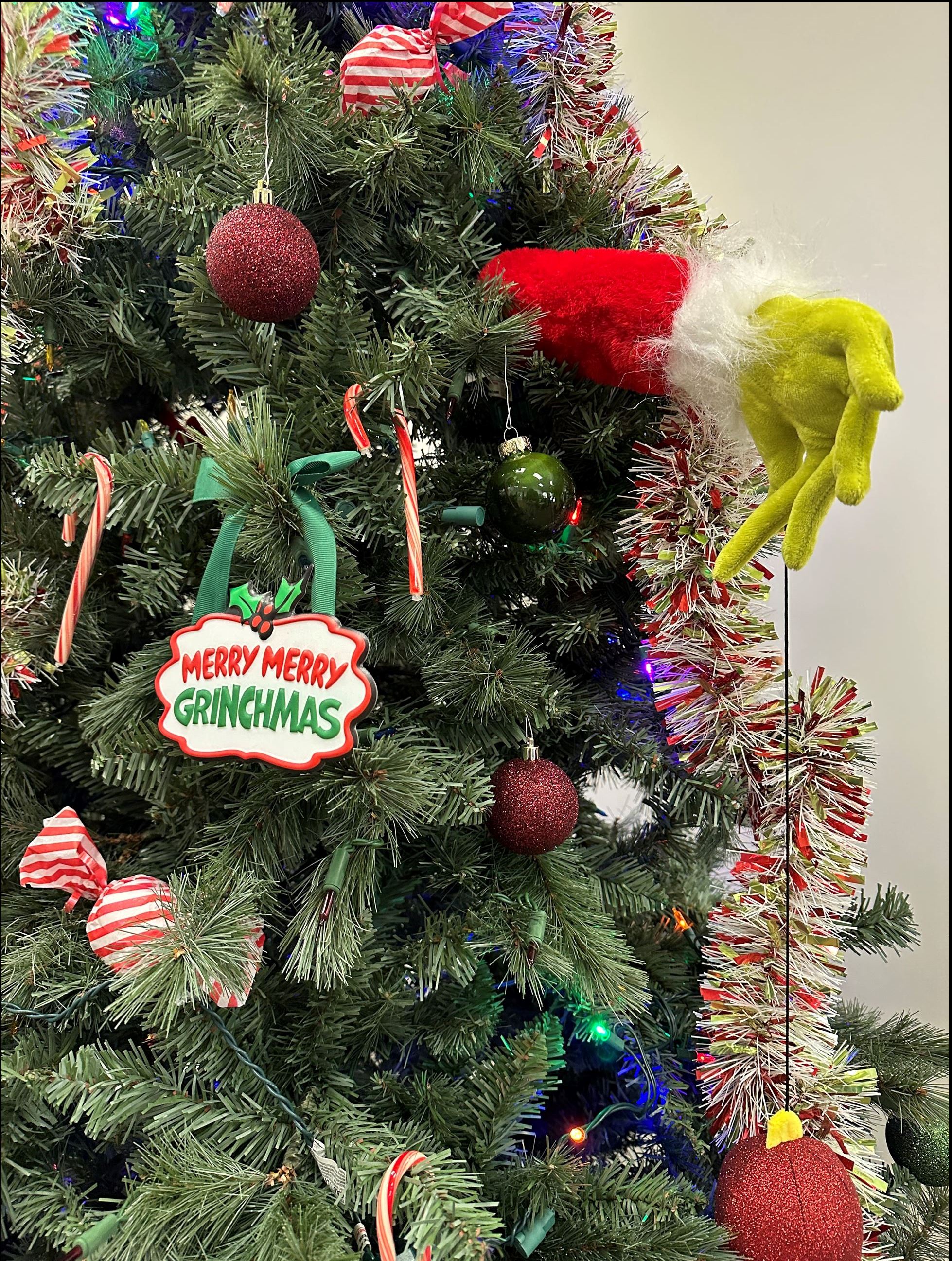 Close up of Christmas tree with Grinch hand sticking out