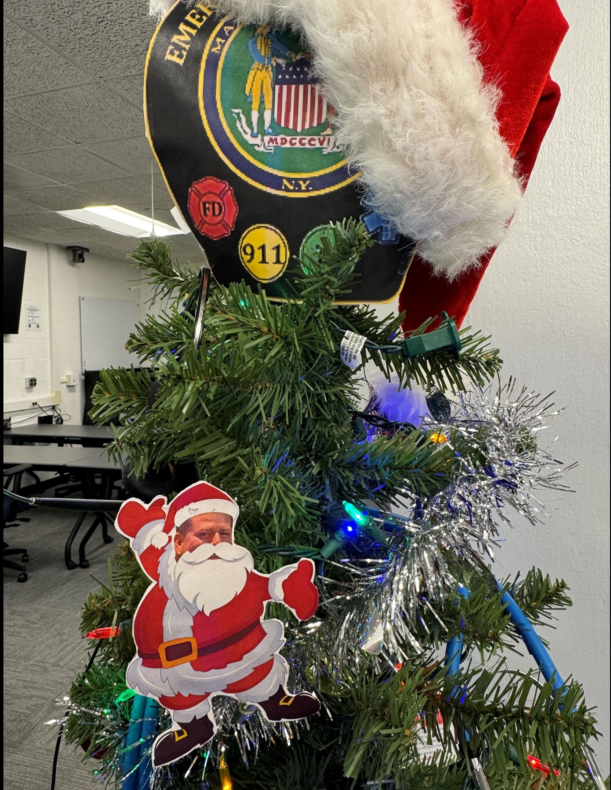 close up of tree with santa hat and decoration